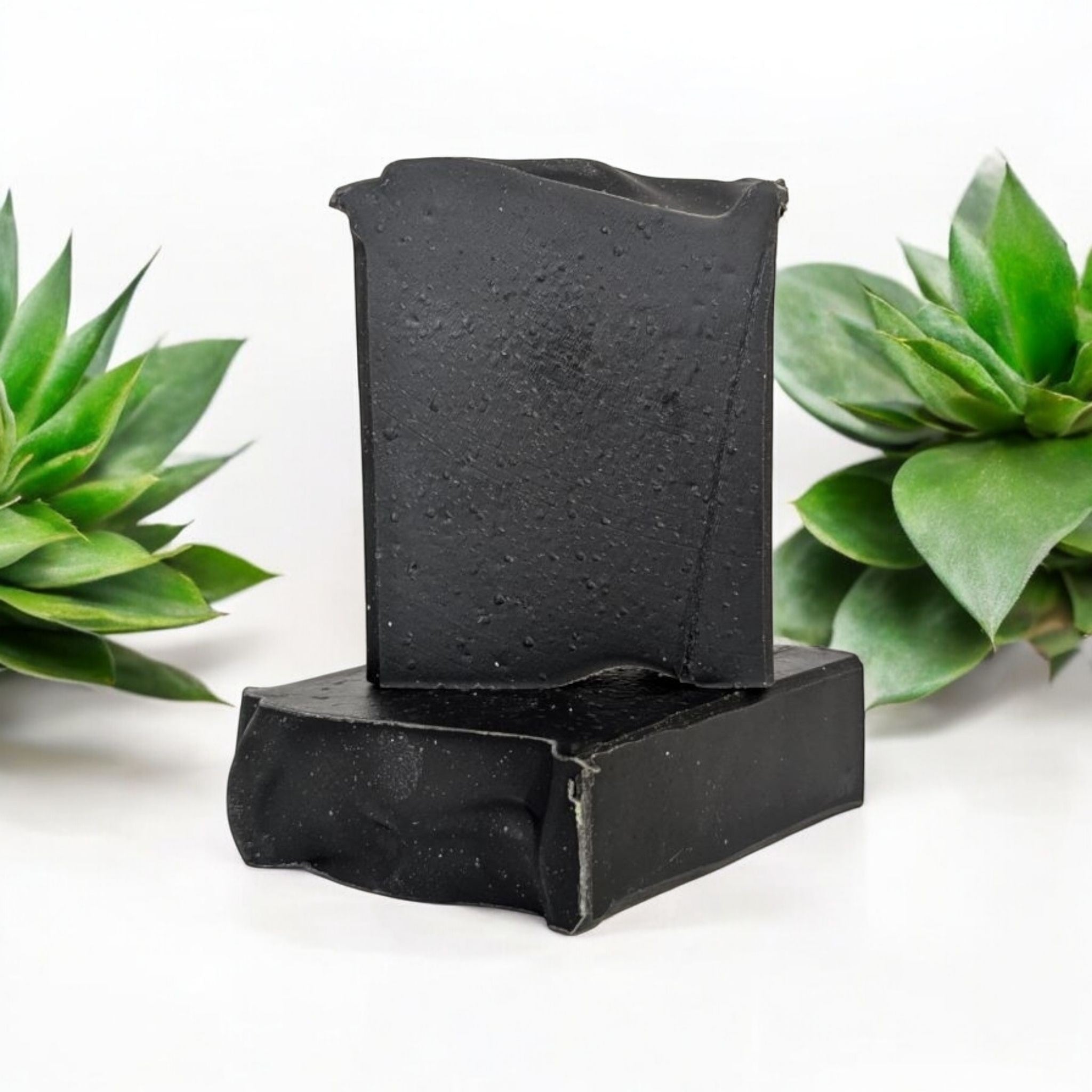 A handcrafted bar of Aloe & Charcoal Face Soap with a rich coconut milk base, infused with activated charcoal, aloe vera, and tea tree oil for a deep, refreshing cleanse.