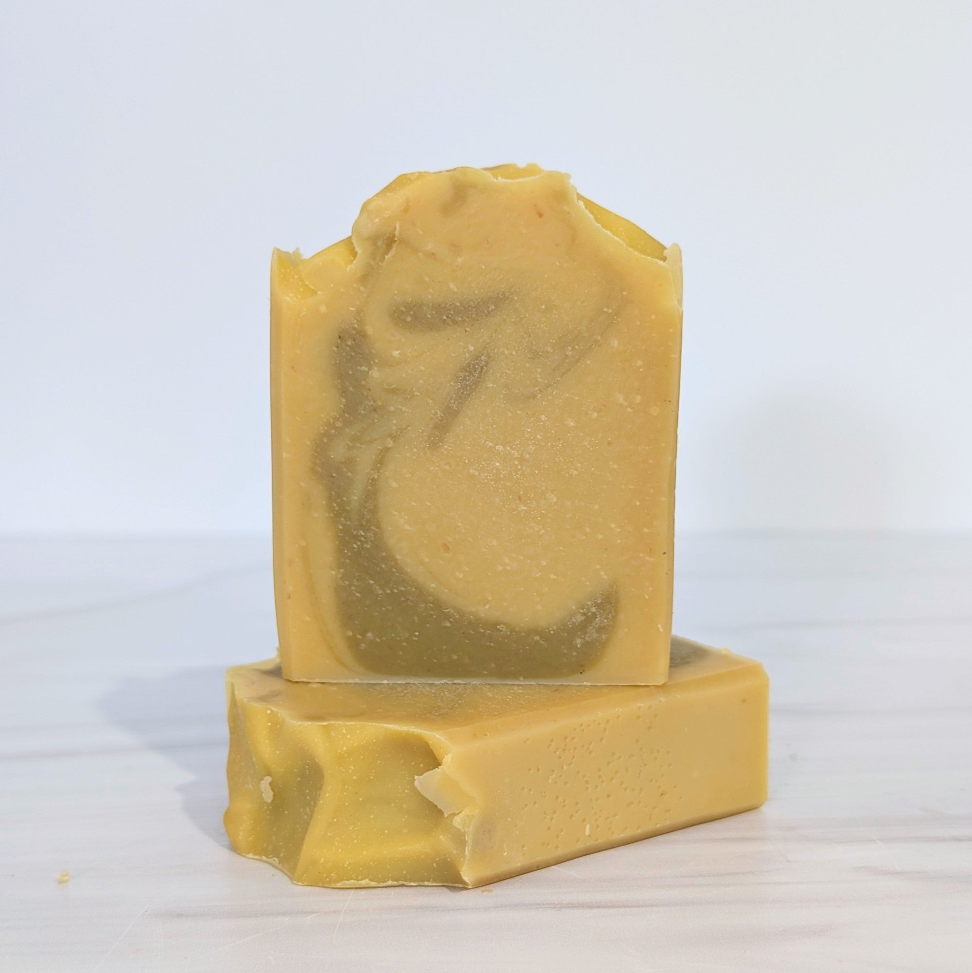 A handcrafted bar of Bentonite Clay & Carrot Face Soap, made with natural carrot puree and bentonite clay for a gentle, unscented cleanse, perfect for sensitive skin.