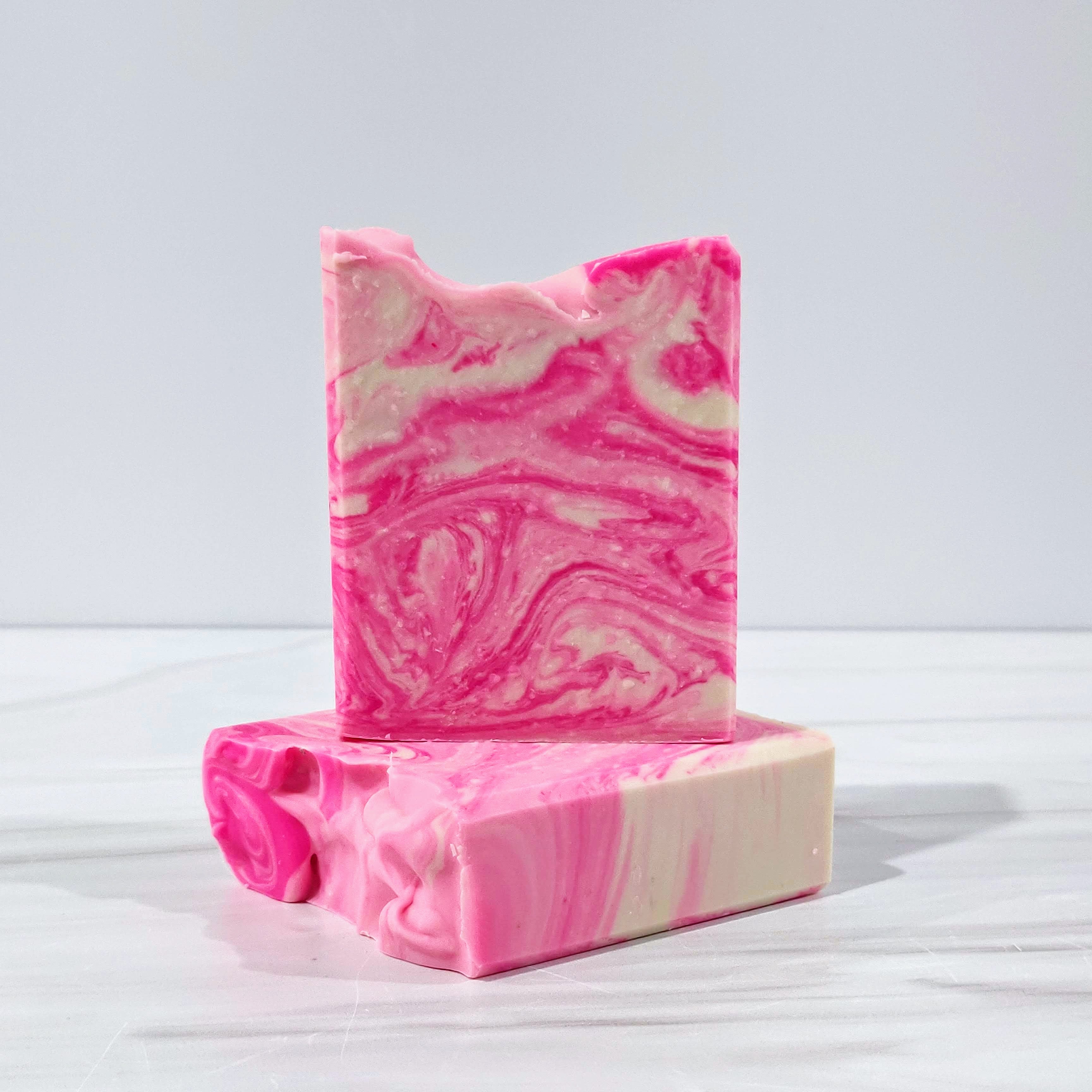 BloomingGrace handmade soap with pink and white marbled swirls, featuring the fresh floral scents of hyacinth, lily of the valley, violets, and wild jasmine. Nourishing and handcrafted in small batches for a luxurious skincare experience.