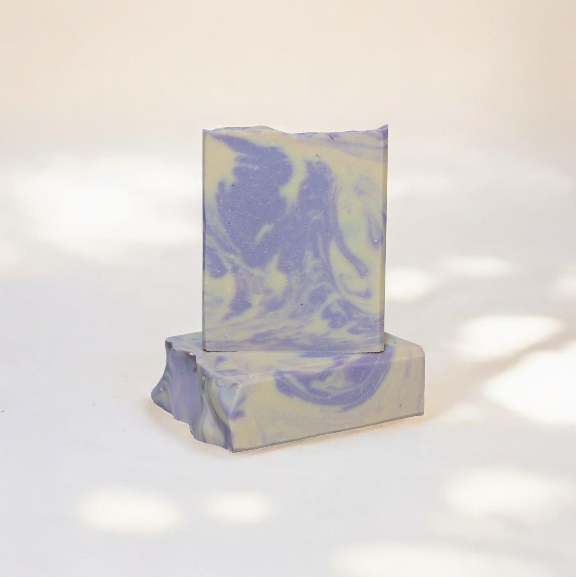 A handcrafted bar of Coconut & Lavender Soap with a rich, creamy lather, infused with coconut milk and lavender essential oil for a soothing, hydrating cleanse.