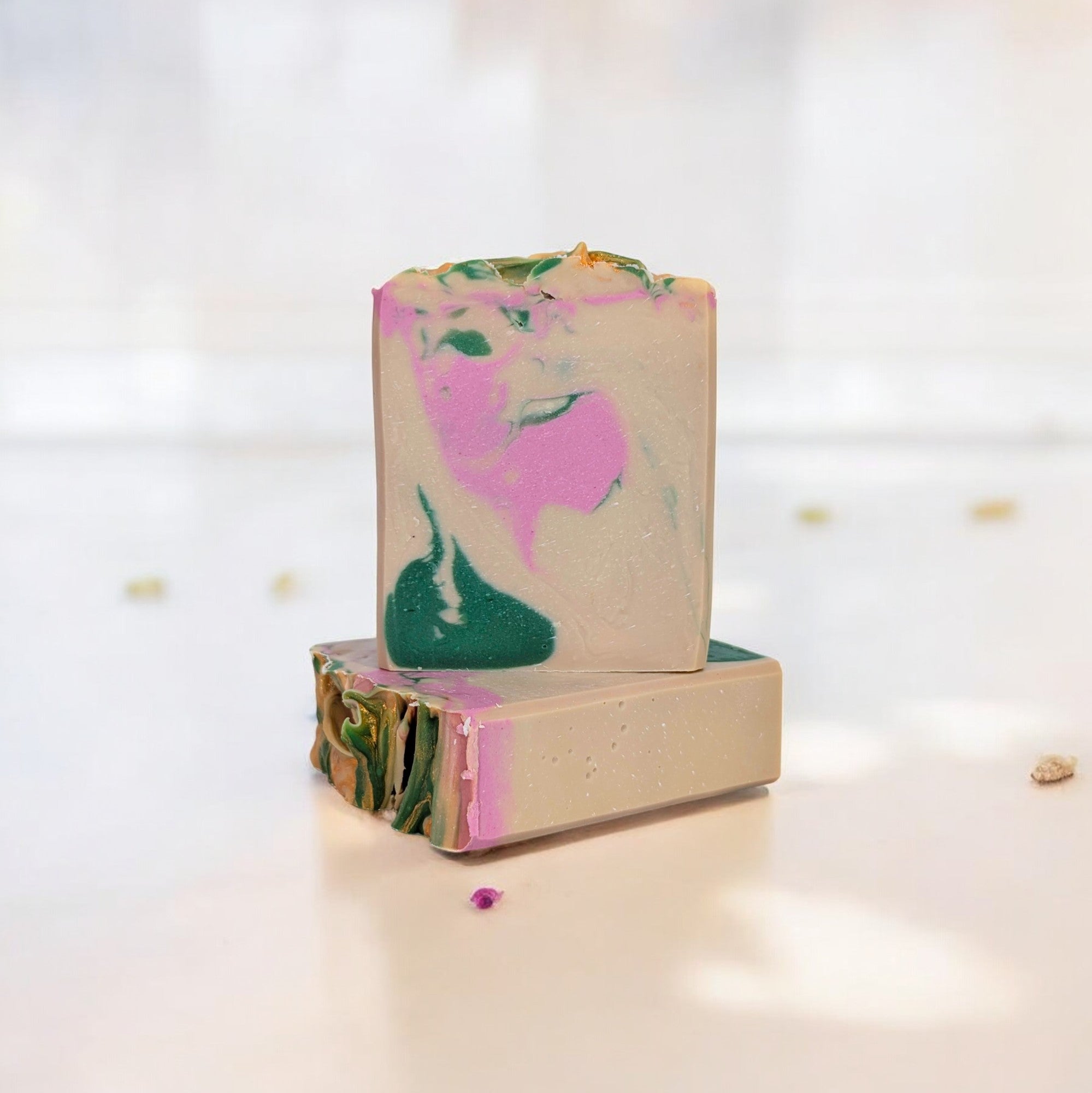 A handcrafted bar of Velvet Moss soap with swirls of green and soft floral tones, infused with tropical fruit, plumeria, and moss for a fresh, sensual experience.