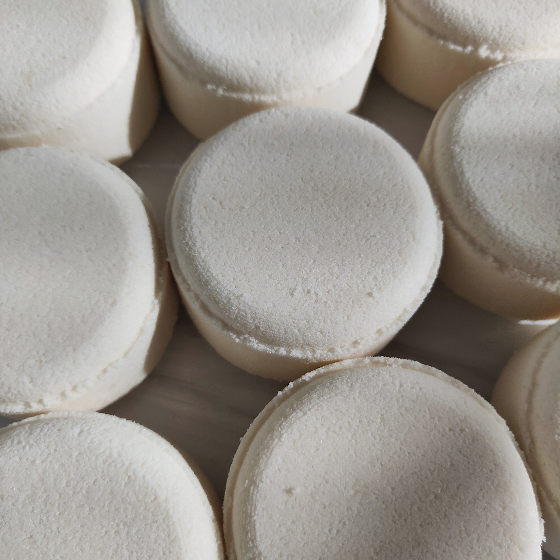 a close up of a bunch of white cupcakes 